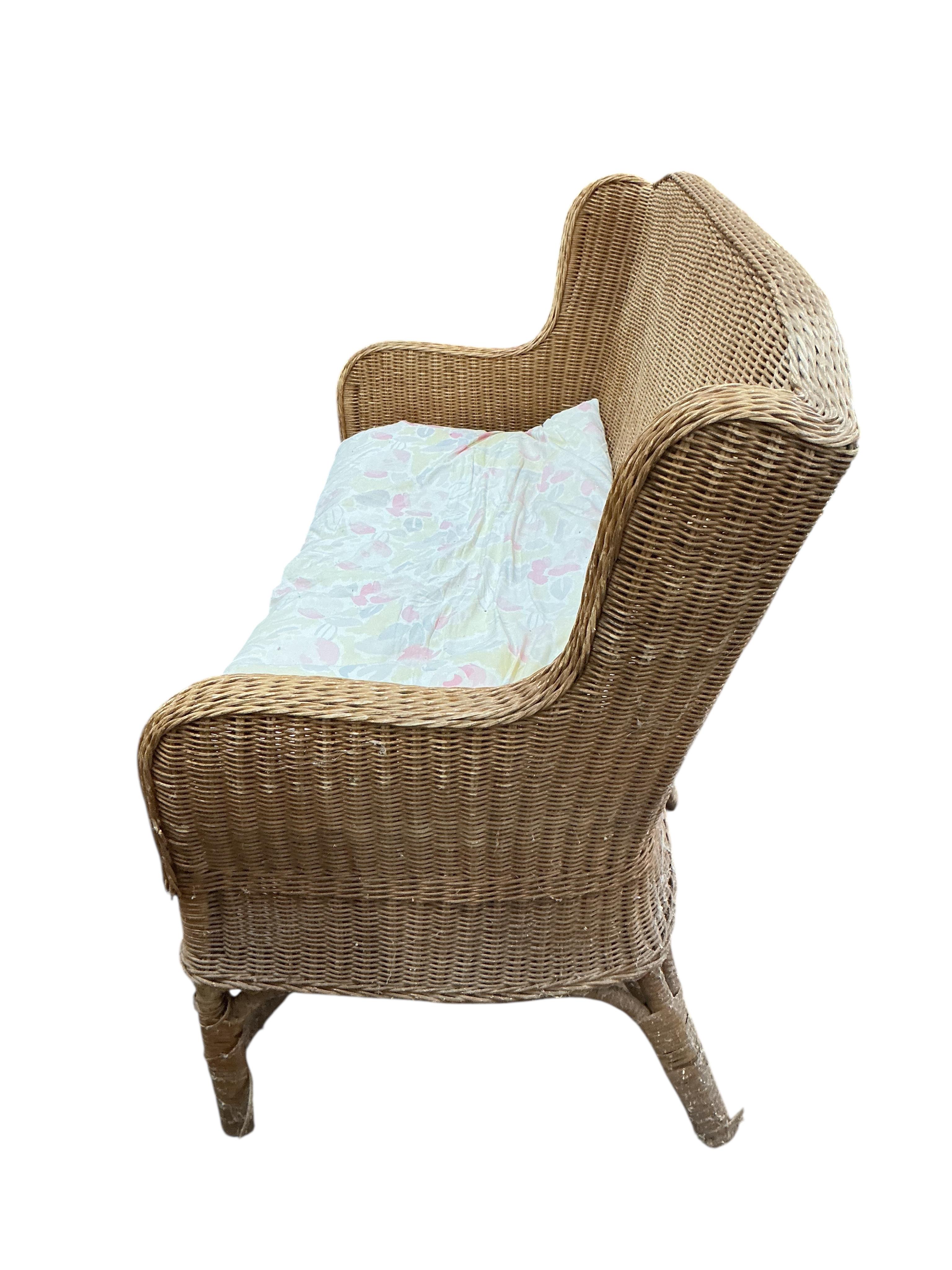 A cane conservatory settee, width 130cm, depth 66cm, height 90cm